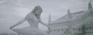 a gif of taylor swift twirling in her dress in the &quot;begin again&quot; music video