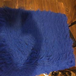 Reviewer photo of the blue faux fur rug completely clean