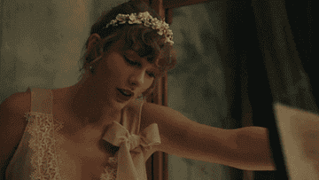 a gif of taylor swift singing in the &quot;willow&quot; music video