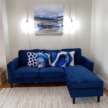 reviewer photo of blue velvet sofa in a living room
