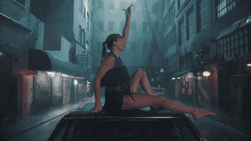 a gif of taylor swift doing a split on top of a car in the &quot;delicate&quot; music video