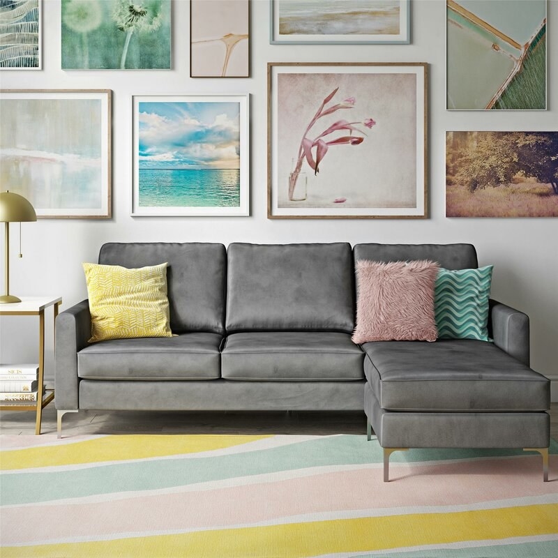 lifestyle image of gray velvet couch in a living room