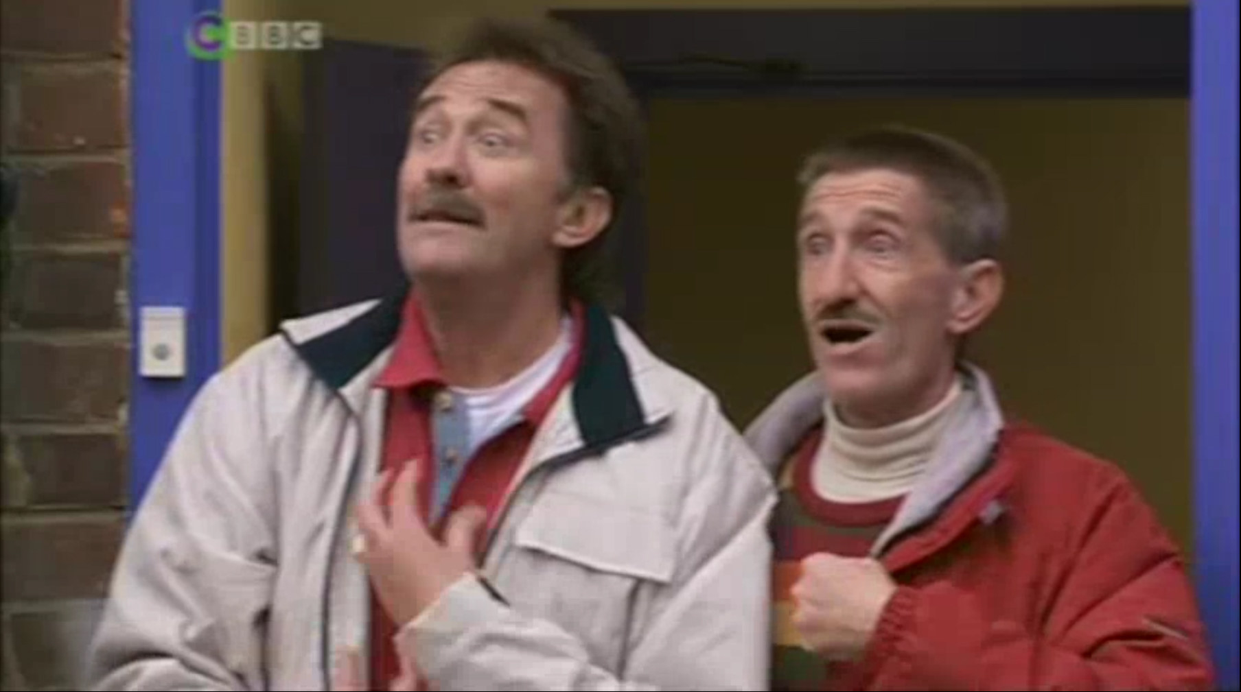 paul and barry chuckle standing in a doorway looking alarmed
