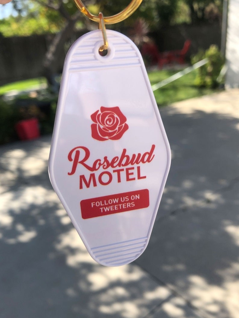 Rosebud Motel keychain with logo that says &quot;follow us on tweeters&quot;