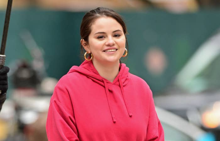 Selena out and about in a hoodie and hoop earrings