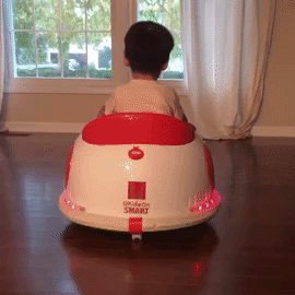 GIF of reviewer's baby, back view, riding bumper car with flashing lights
