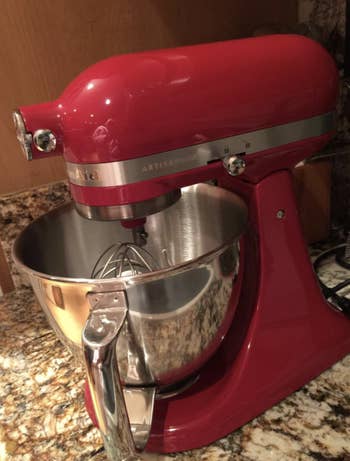 the mixer in red sitting on a counter