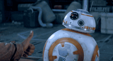 Droid BB-8 opens a compartment in his stomach to reveal a lighter that he ignites in response to Finn as John Boyega giving him a thumbs-up in &quot;The Force Awakens&quot;
