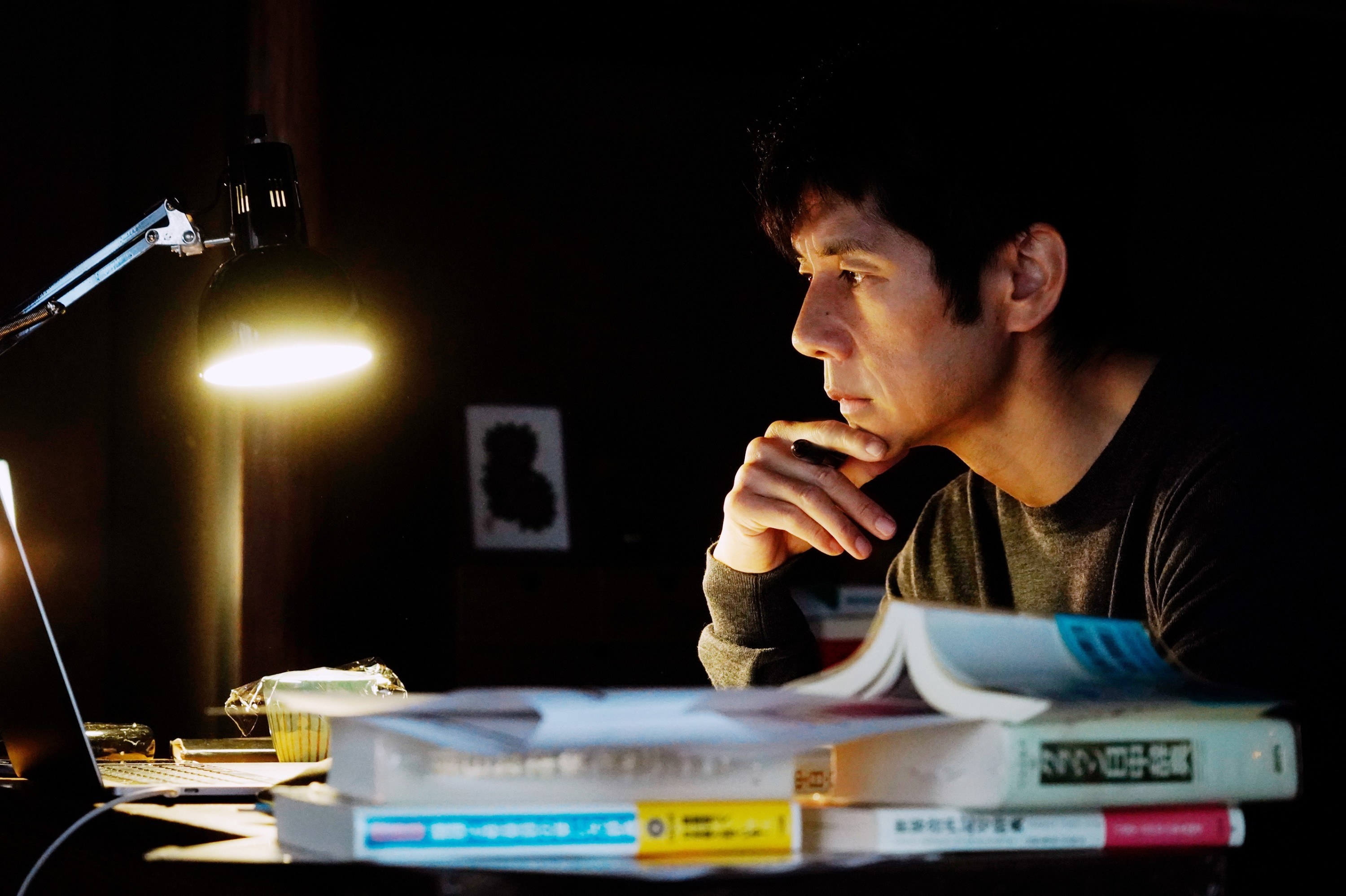 Hidetoshi Nishijima studies at a desk