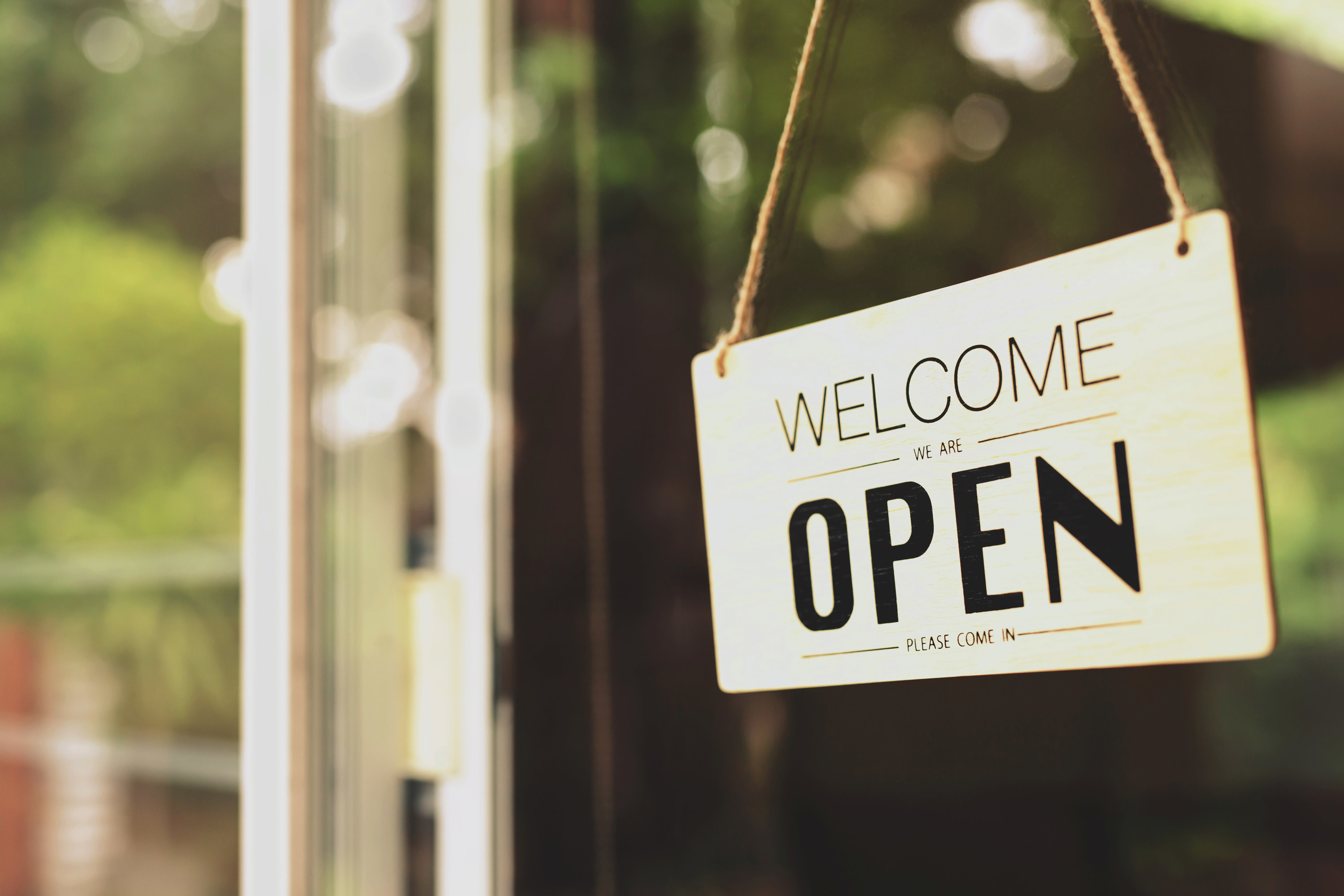 A sign on door that reads &quot;Welcome we are open&quot;