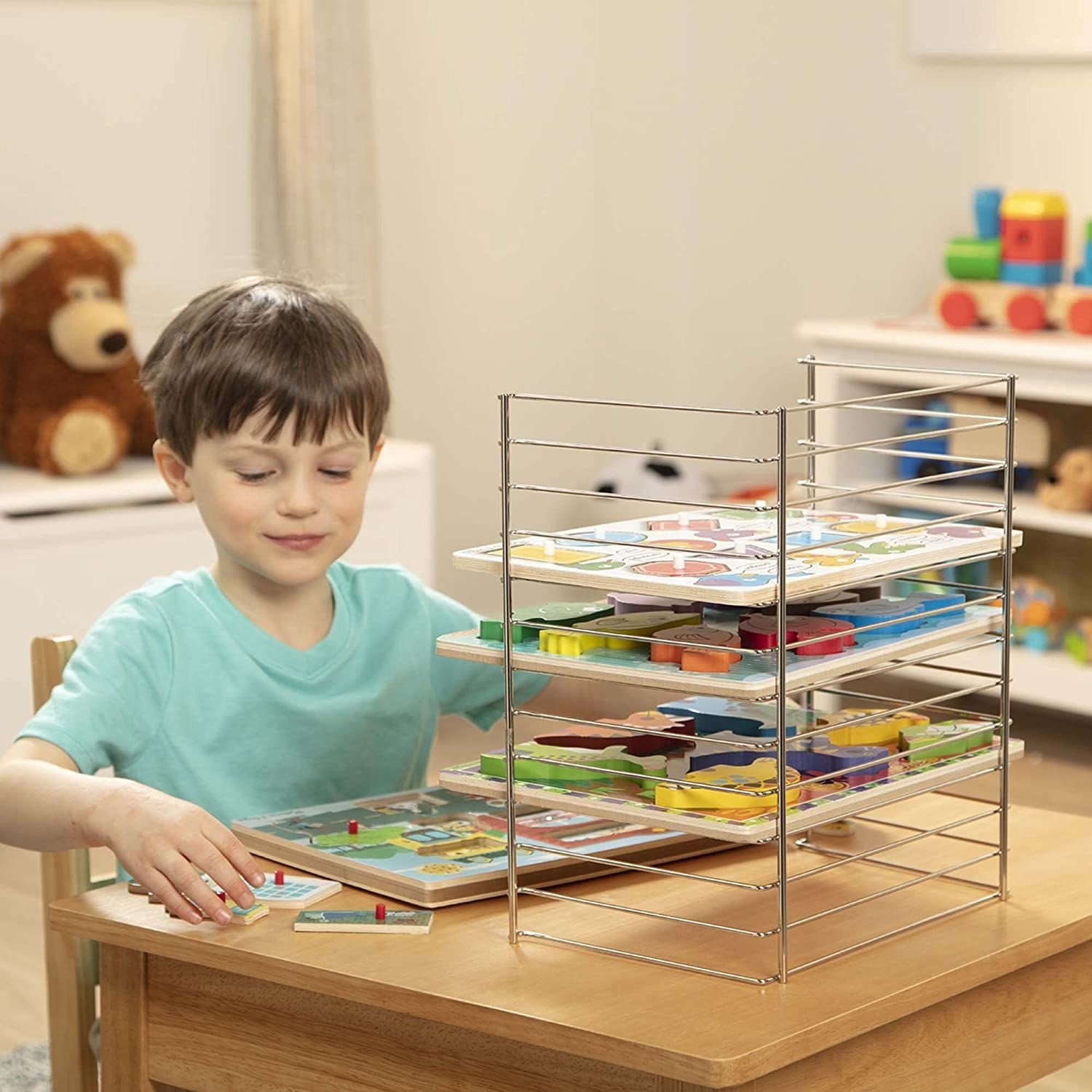 kid pulling simple knob puzzle off storage rack