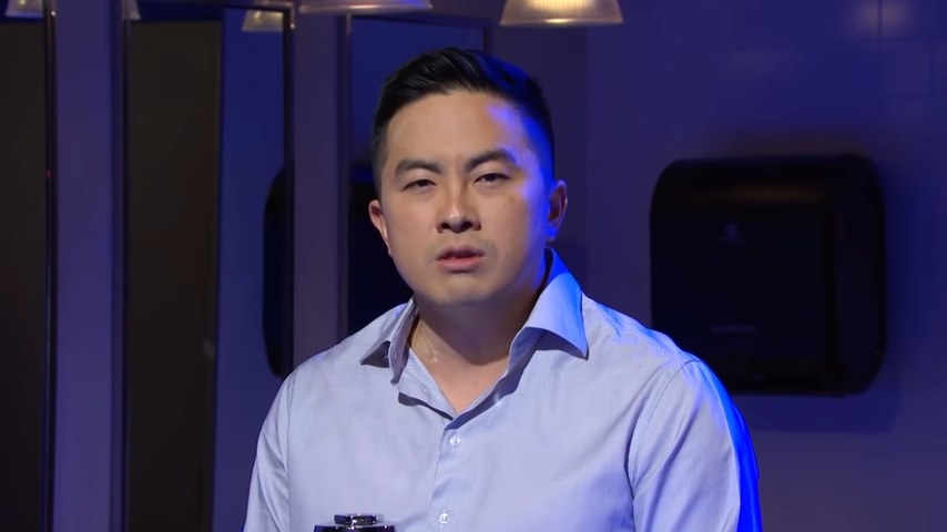 Bowen Yang staring at the camera in a men&#x27;s room in &quot;Saturday Night Live&quot;