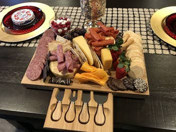 The charcuterie board loaded with meats and cheese, showing knives in slide-out drawer