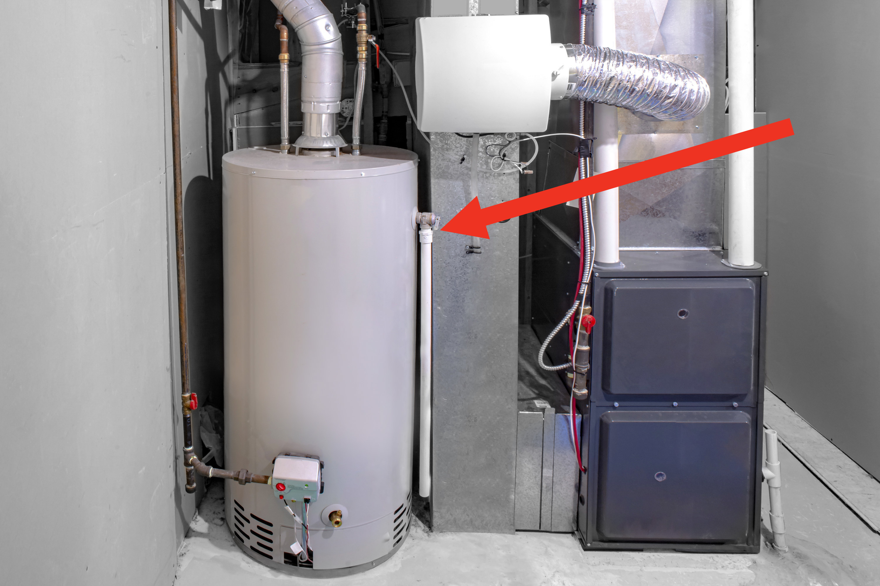 Arrow pointing to a large hot water heater
