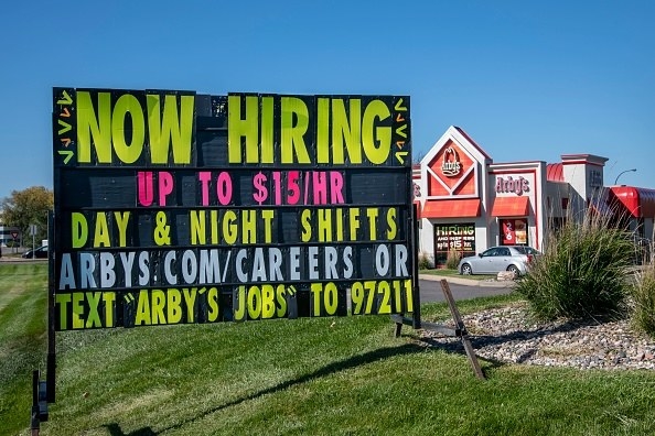 A now hiring sign outside of an arby&#x27;s