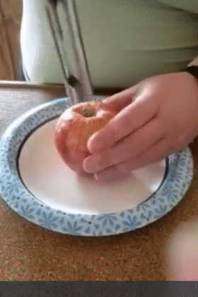 GIF of reviewer using the corer to remove the core from an apple