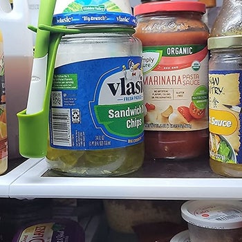 Reviewer photo of the snack fork attached to a jar of pickles in a fridge