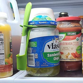 Reviewer photo of the snack fork attached to a jar of pickles in a fridge