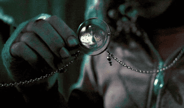 Hermione holding a time turner