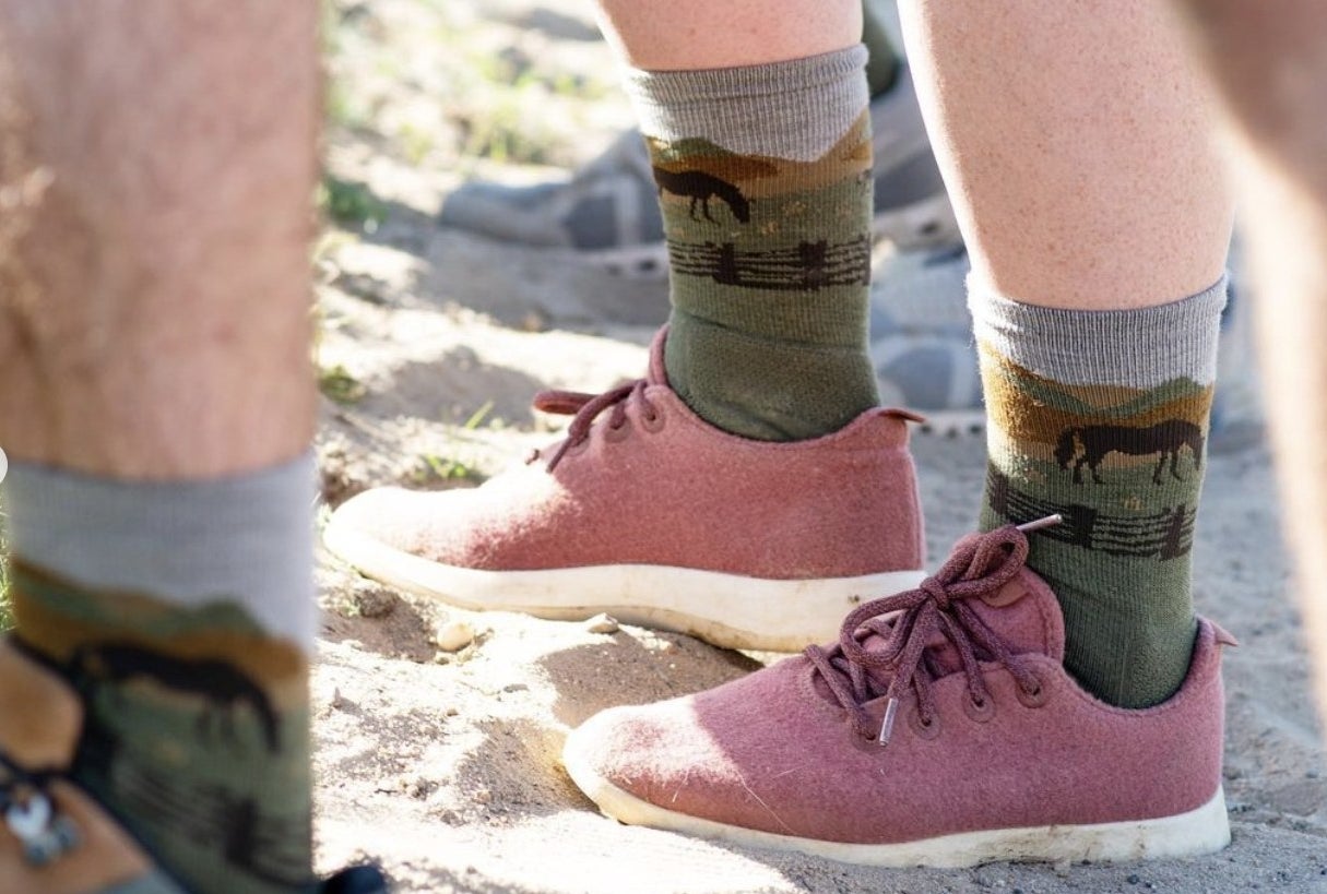 Close-up of someone's ankles and shoes in farm-design crew style socks