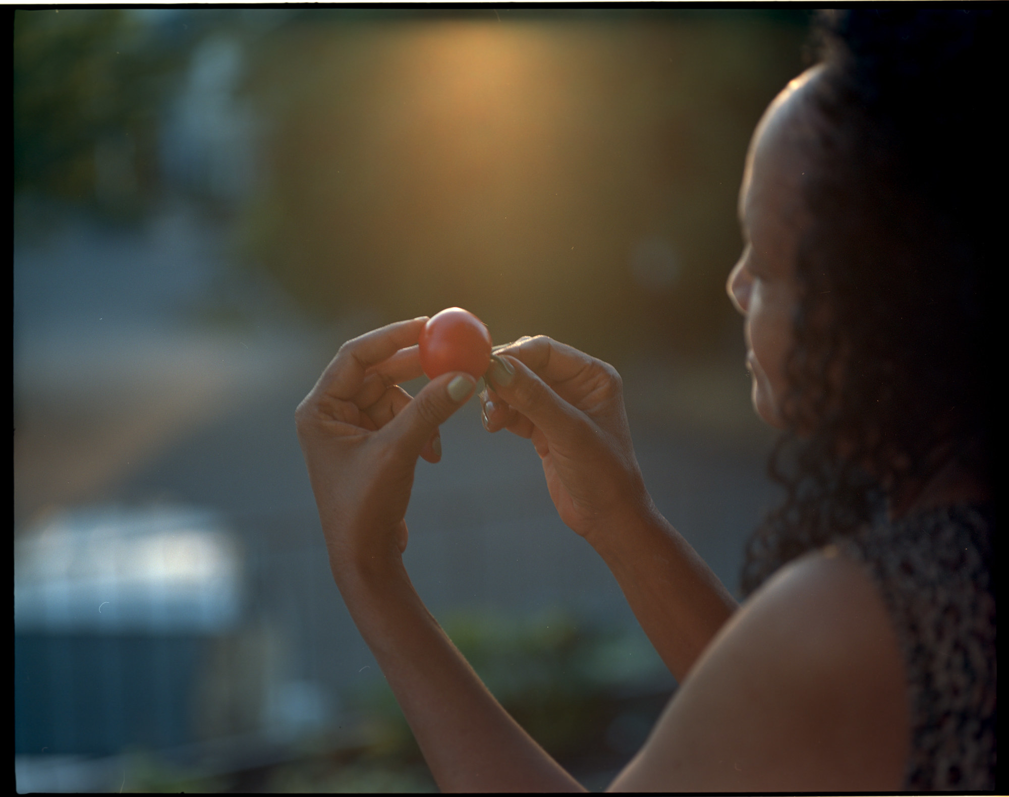 A woman holding a tomato