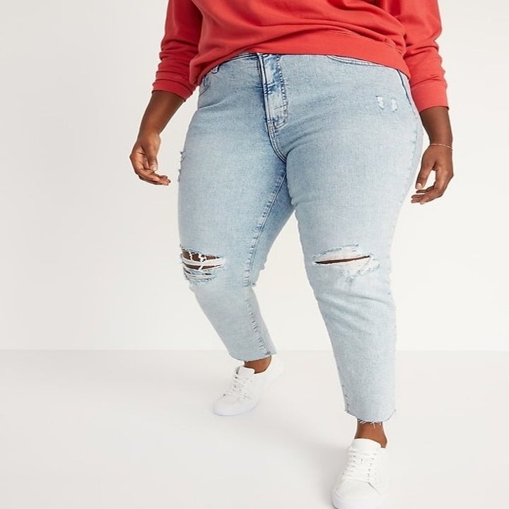 Model wearing ripped jeans