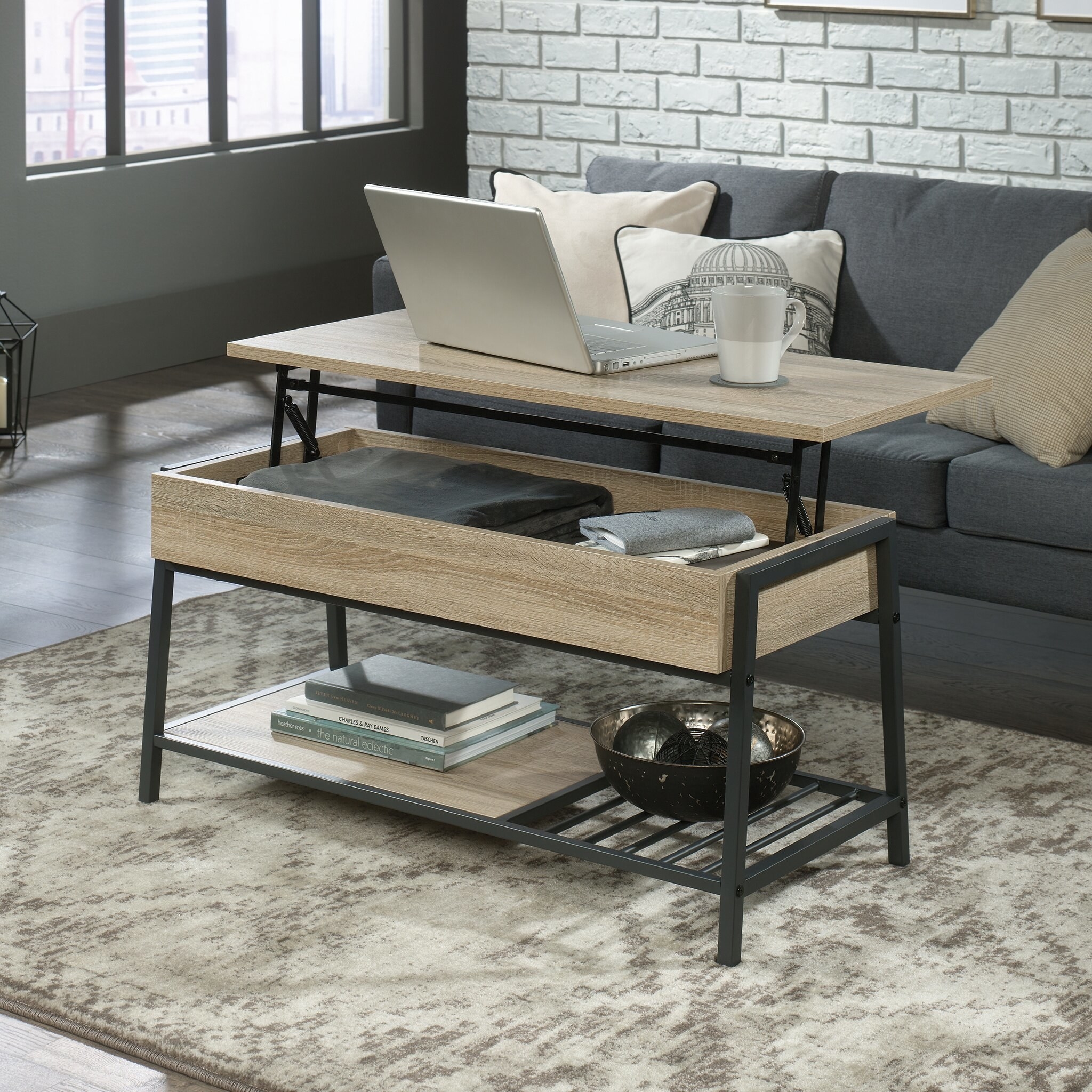 the oak wood coffee table with the top lifted and elevated to show the storage capacity