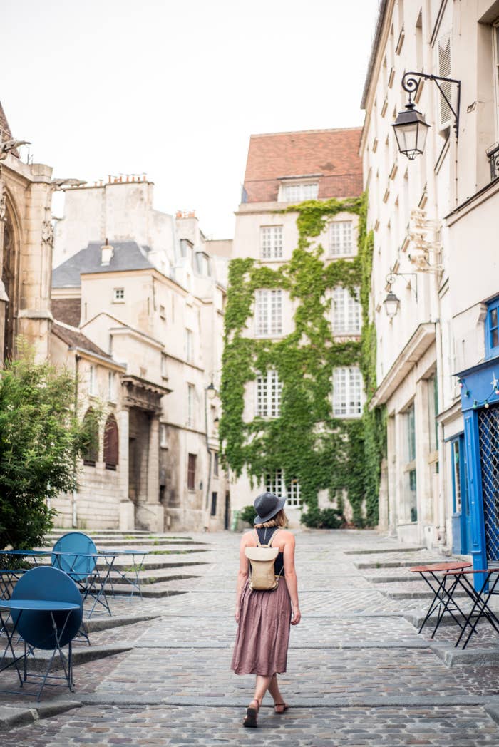 A woman walking on a quiet street.