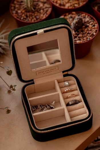 Reviewer image of green velvet jewelry box filled with rings and earrings