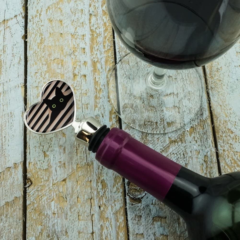 A wine stopper showing a black cat sticking its head through white blinds