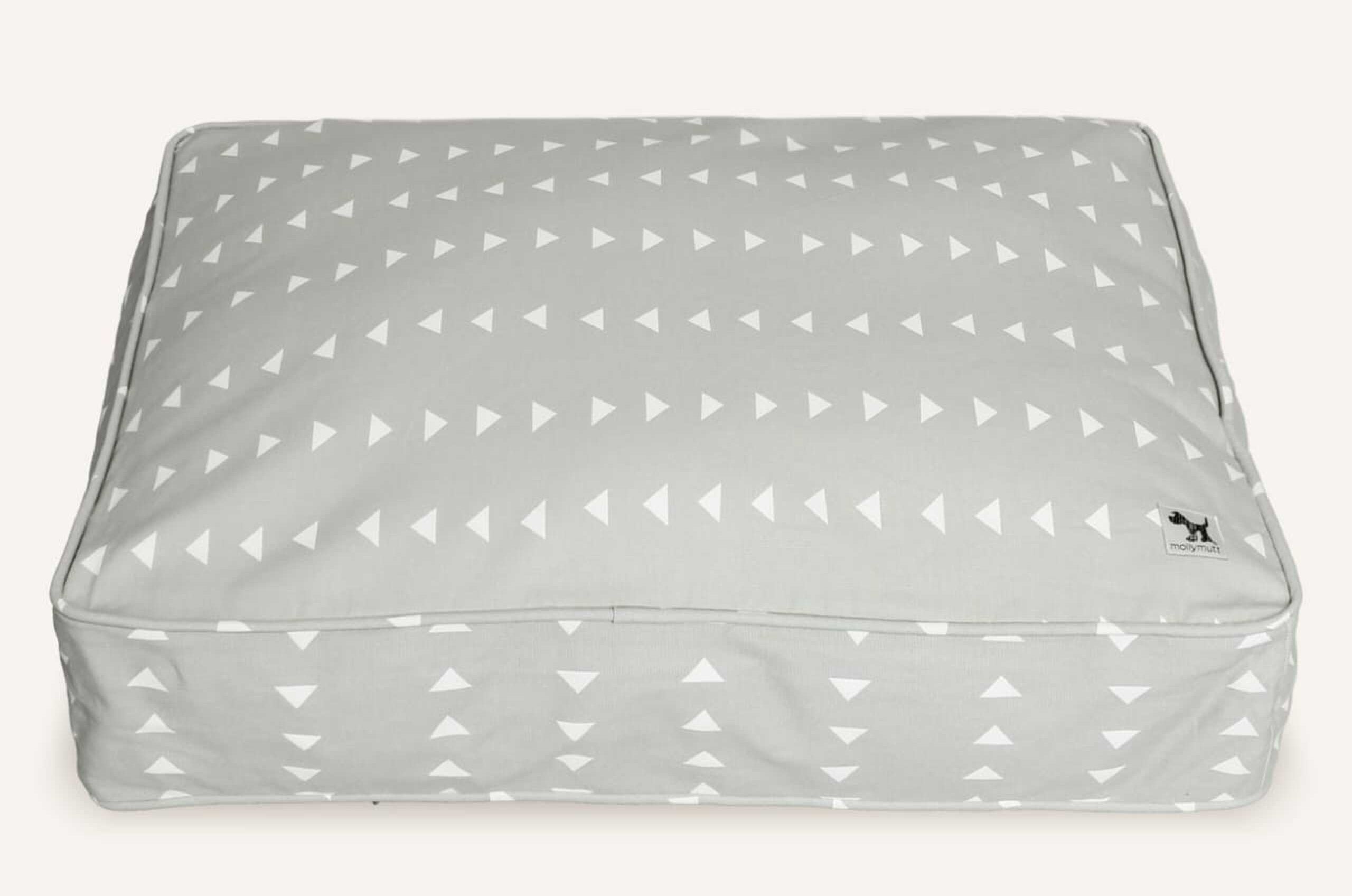 gray square dog bed with white triangle pattern on it