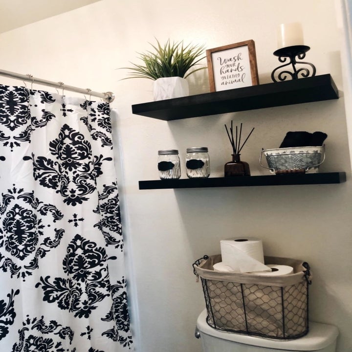 another reviewer showing two black  shelves in the bathroom