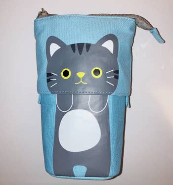 blue rectangular pouch with a gray cat on it