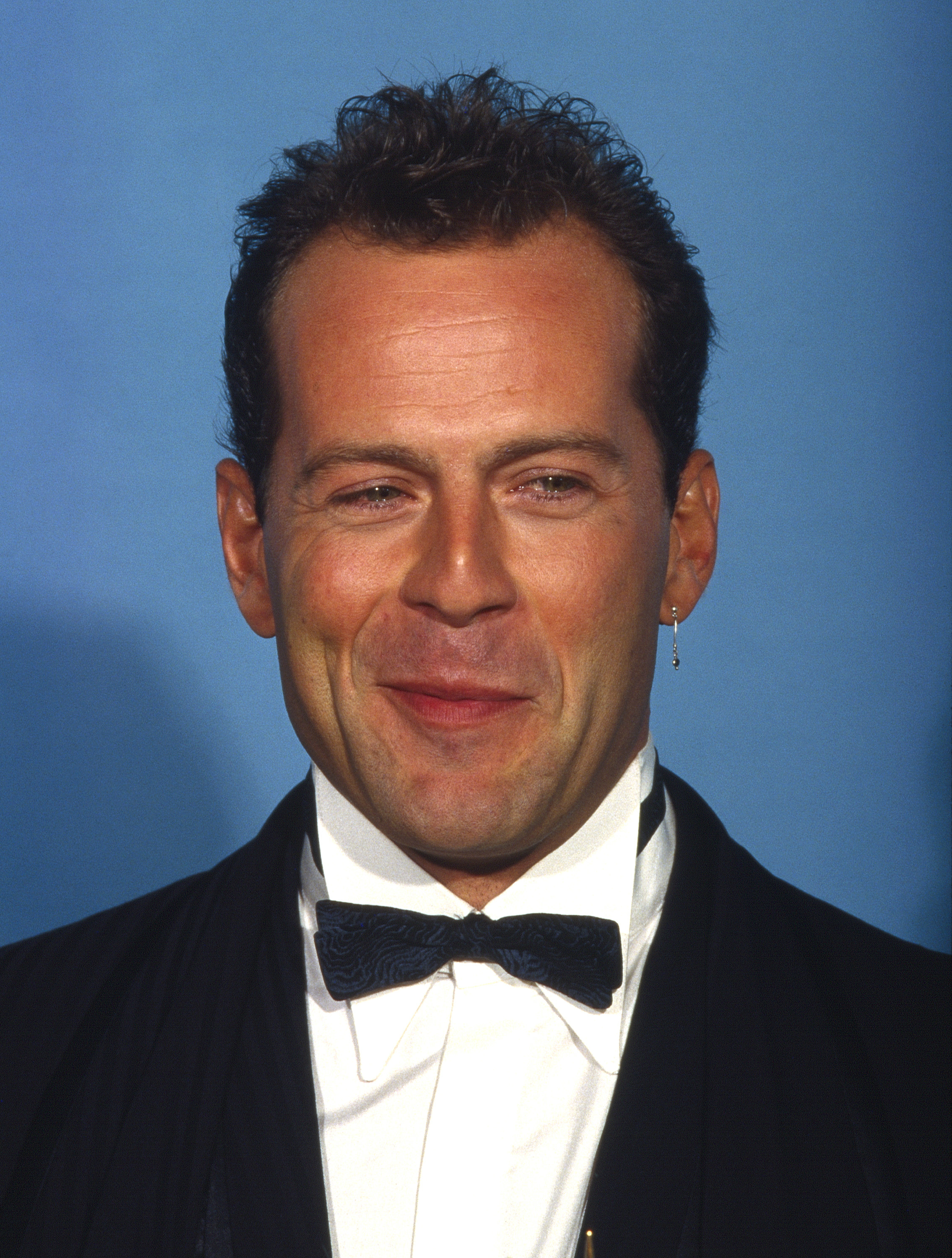 Bruce Willis smirking at an award show