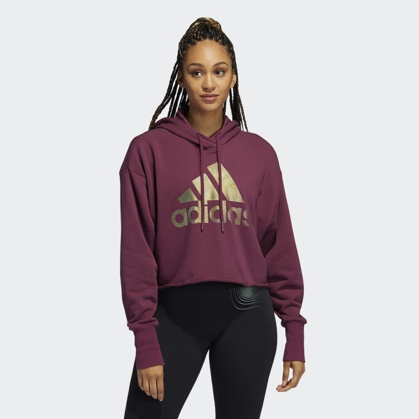 model wearing hoodie purple with gold adidas logo