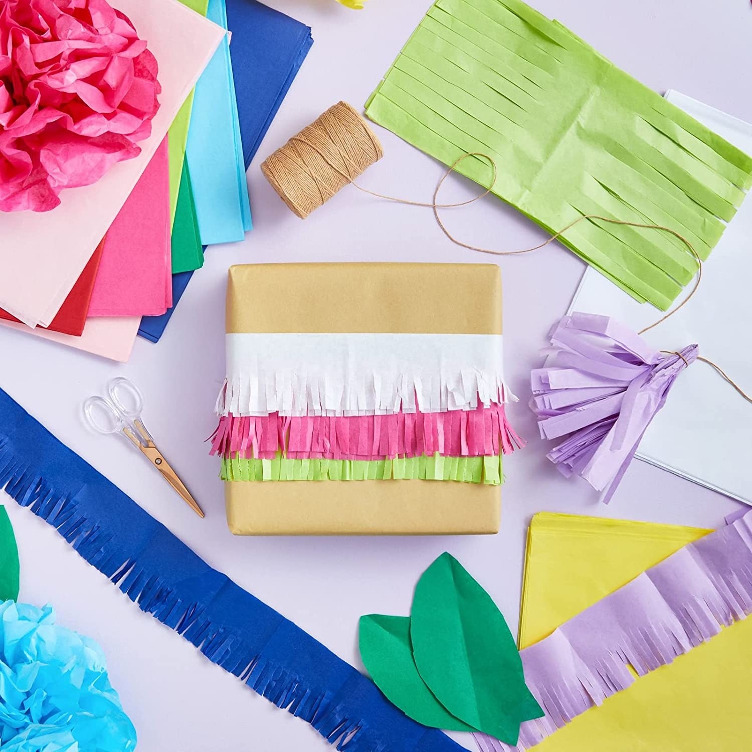 The multicolored tissue paper being used to decorate a box