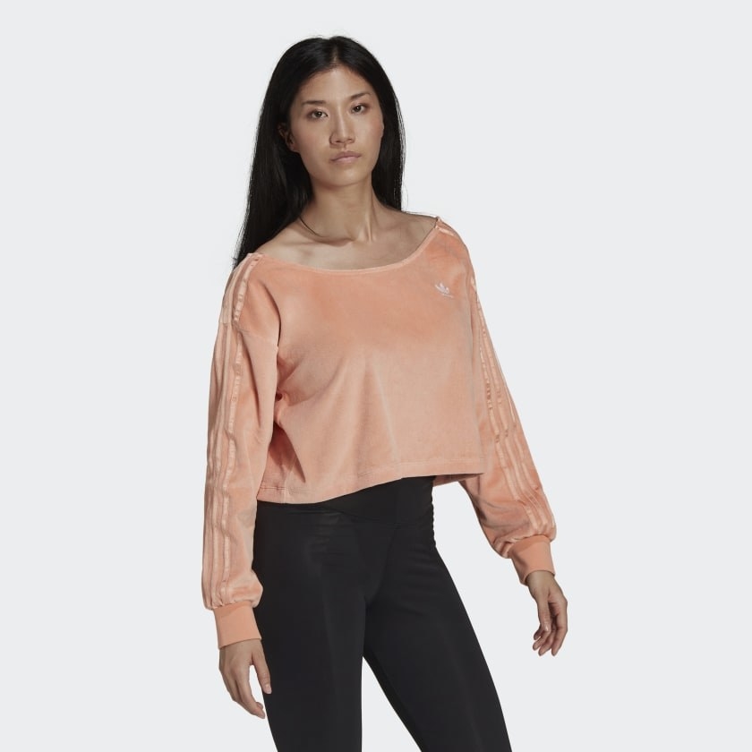 Model wearing the peach long sleeve sweater