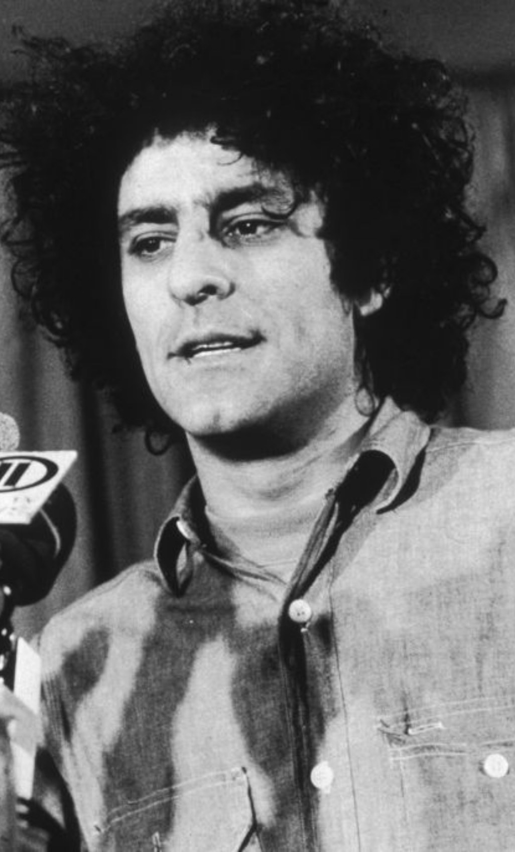 Hoffman speaking at a press conference in 1969
