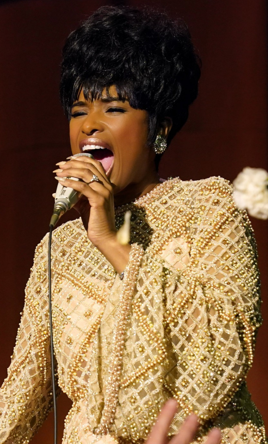 Hudson wearing long, beaded dress while performing as Franklin