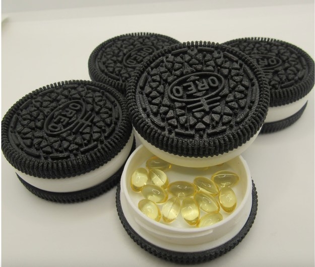 An Oreo-shaped container with pills inside
