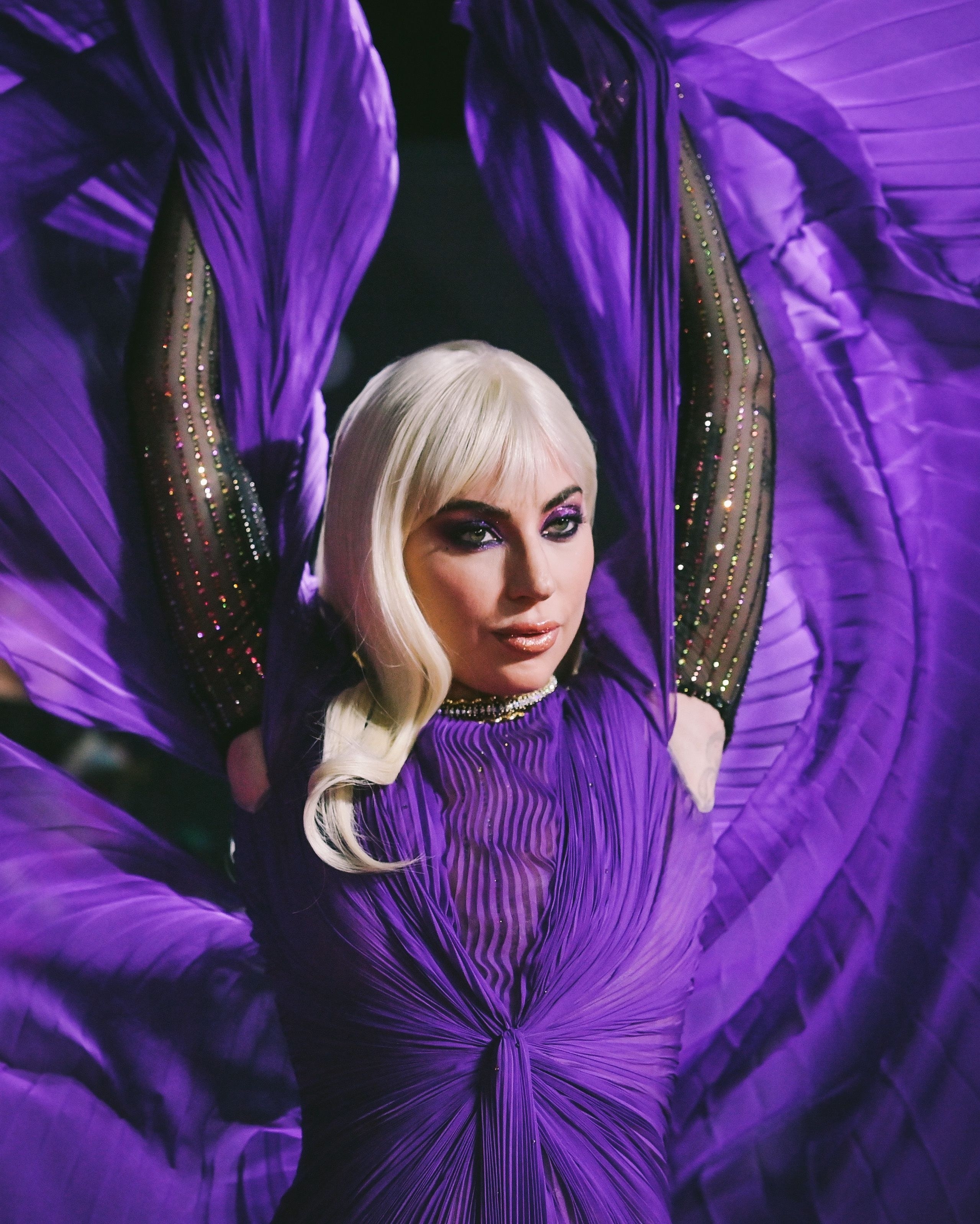 Lady gaga in a purple dress for house of gucci