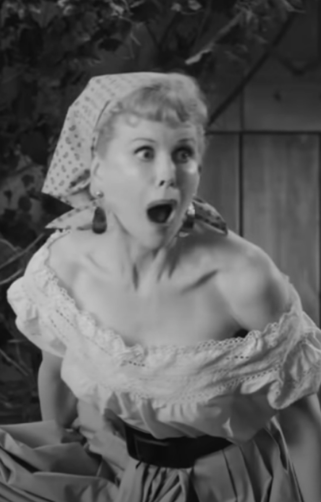 Kidman making a shocked, classic Lucille Ball face while stomping grapes