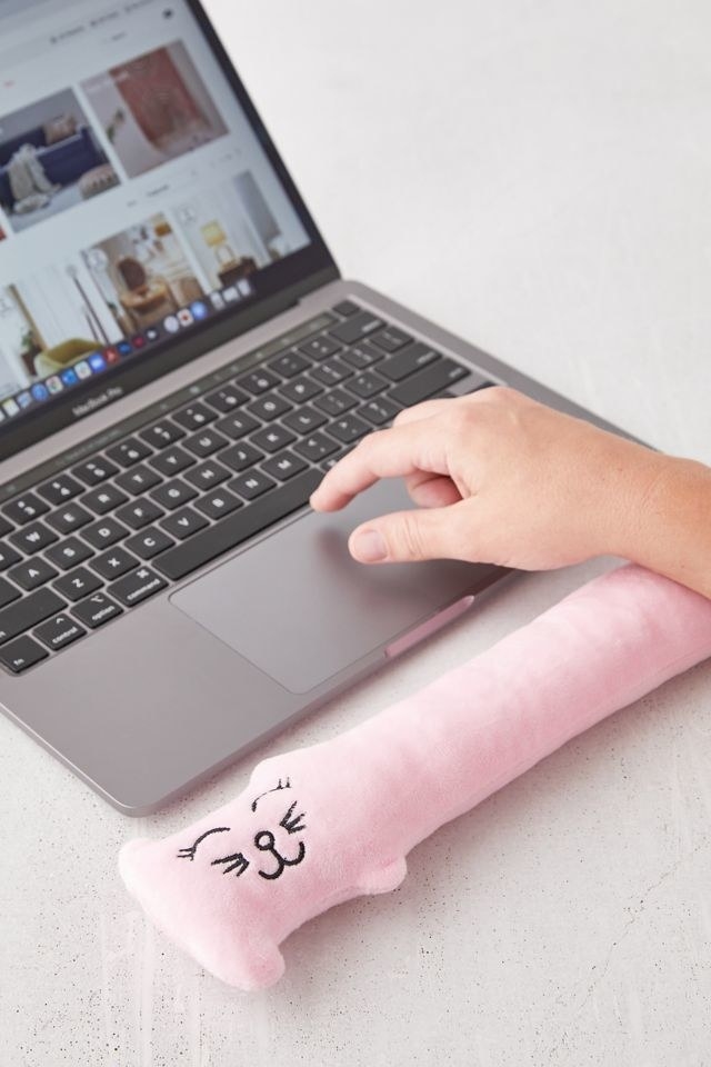 A light pink keyboard wrist rest covered in soft fleece
