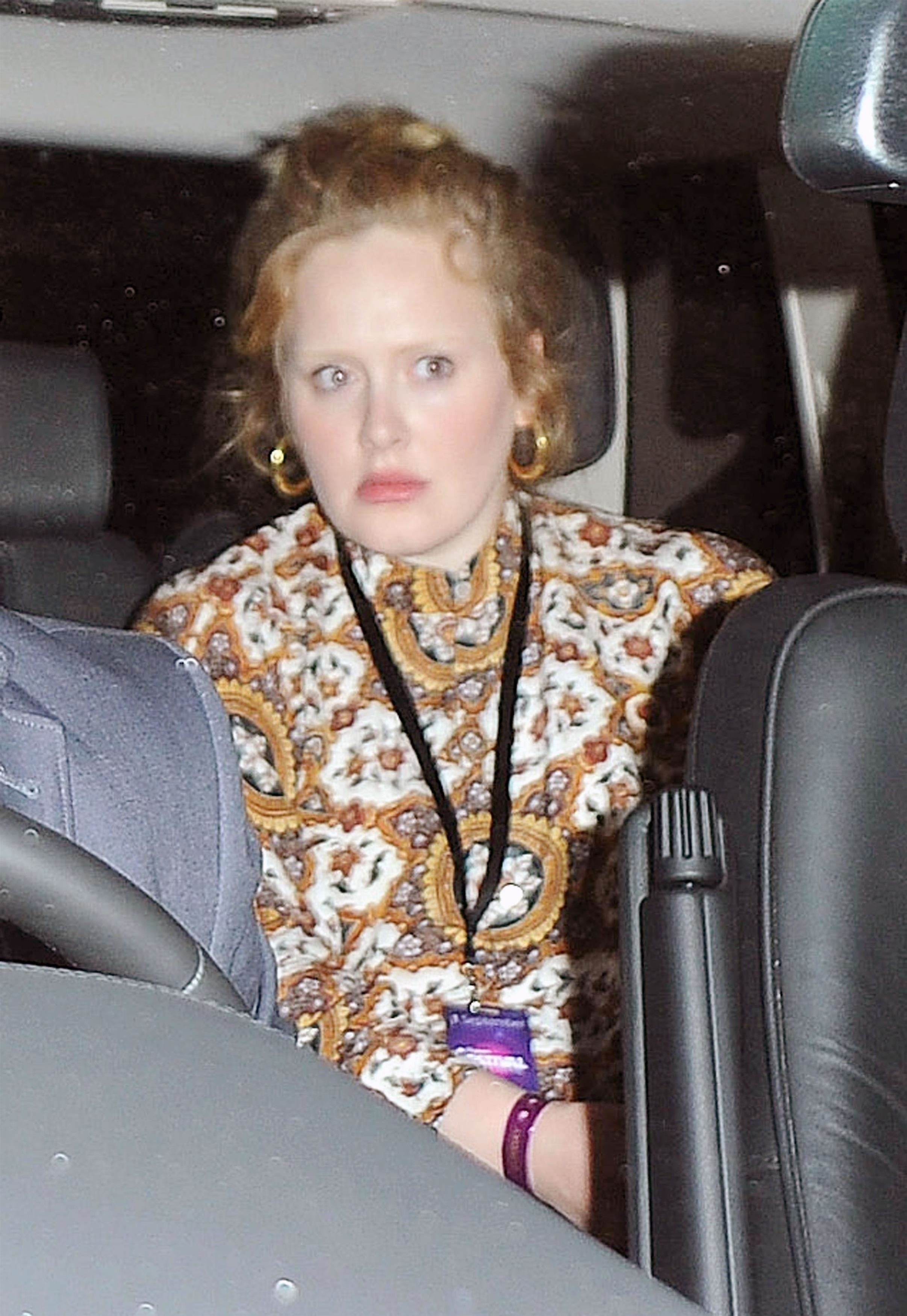 Adele in the backset of a car with barely visible eyebrows
