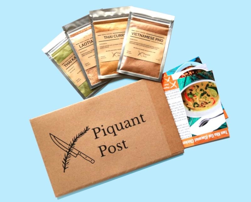 a box that says &quot;piquant post&quot; next to several recipes cards and four spice packets