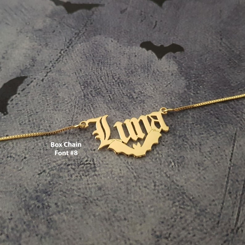 name necklace that says luna with bat underneath
