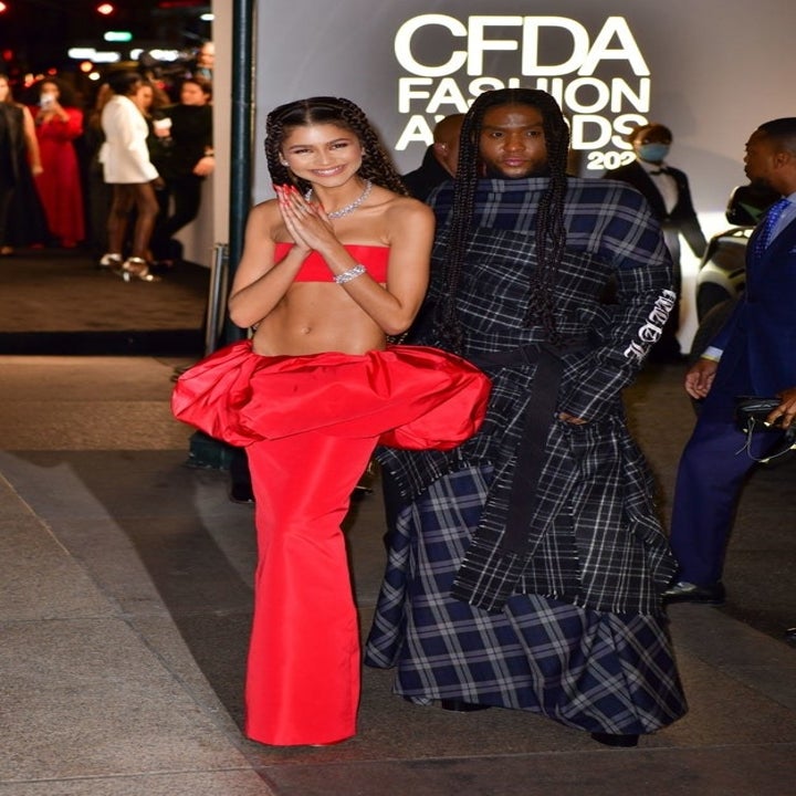 Zendaya wearing a crop top and fitted matching skirt with a bubble waist as she poses next to Law outside of the CFDA awards