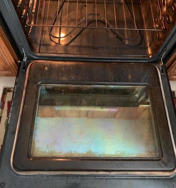 Reviewer photo of dirty oven after using Goo Gone cleaner