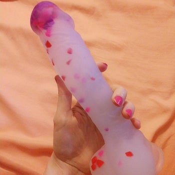 Reviewer holding dildo