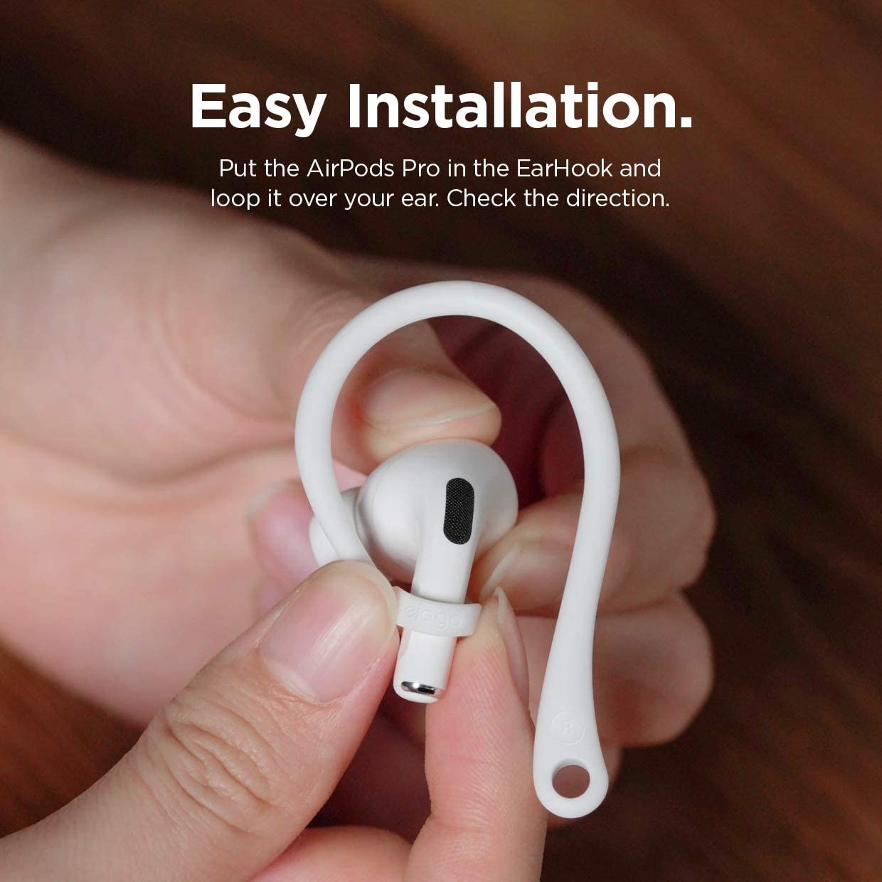 A person putting a hook onto an AirPod